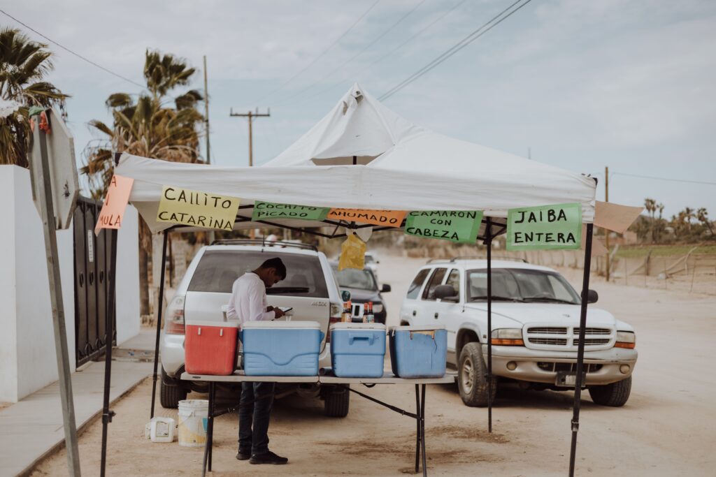 Candelaria Escape Man selling seafood at roadside stall in El Pescadero, Mexico